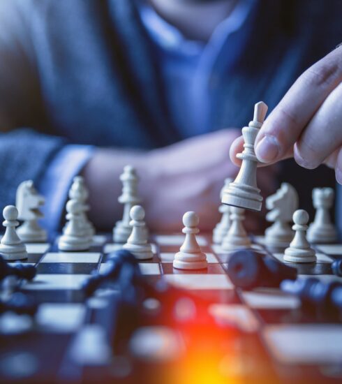 depth of field photography of man playing chess
